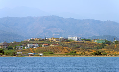 Mediterranian island with mountain and houses.