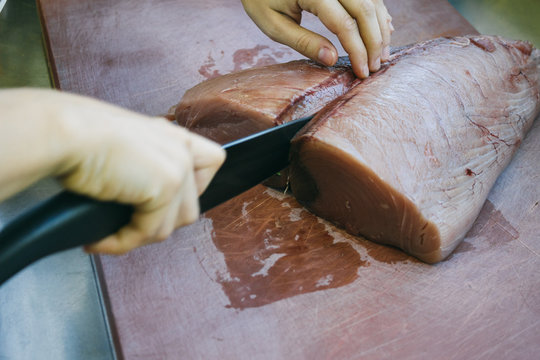 Cook Cutting A Tuna Loin