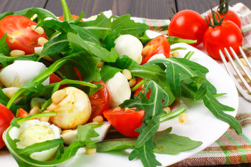 Salad with arugula on a wooden background
