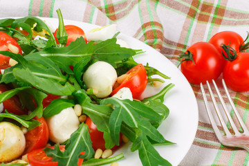Salad with arugula on a fabric background