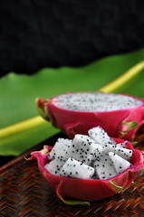dragon fruit with banana leaf on background