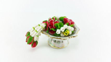 Artificial temple flower garland on tray with pedestal