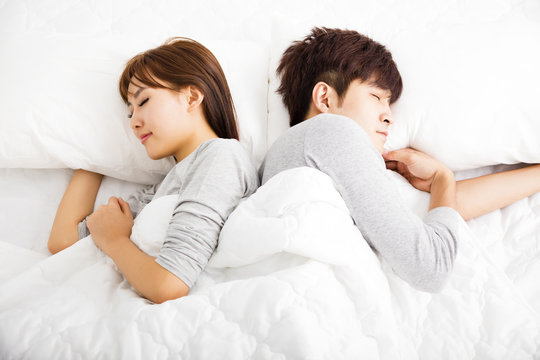 happy young lovely couple sleep in  bed