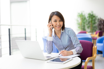 Asian Businesswoman sitting at her desk in an office