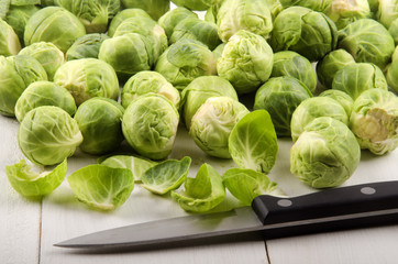 trimmed brussels sprouts and a kitchen knife