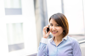 Asian businesswoman using mobile phone at office