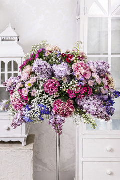Bouquet of carnations, lilacs and chrysanthemums, wooden lantern