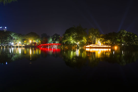 The Huc bridge across Hoan Kiem lake at night in Hanoi, Vietnam
