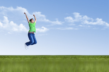 Young boy is jumping in nature on green grass © COSPV
