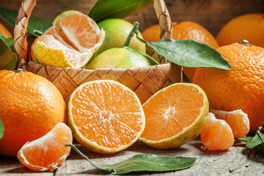 Cut ripe juicy orange tangerines, selective focus