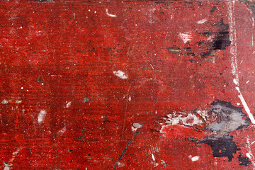 Wood with chipped red paint. Grunge style background.