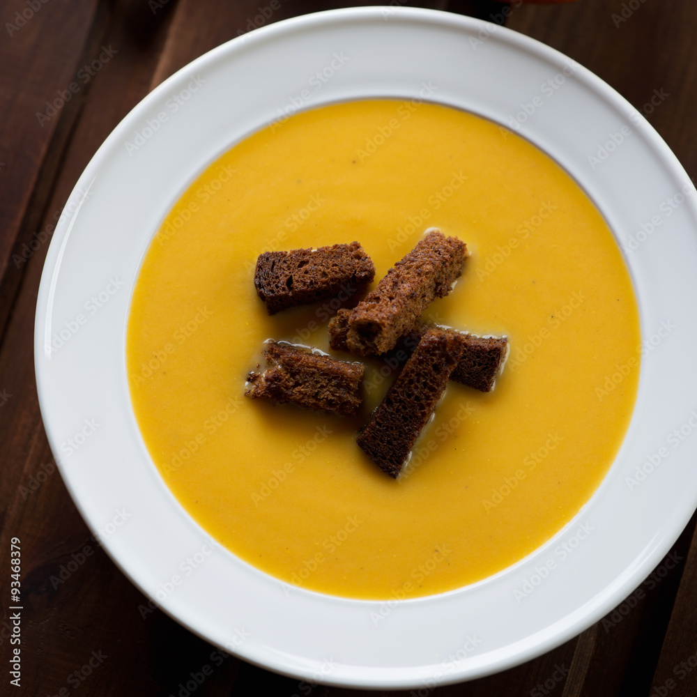 Sticker Pumpkin cream-soup with croutons, above view, close-up