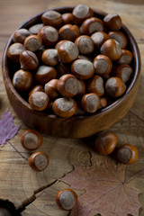 Closeup of a wooden bowl with freshly gathered hazelnuts