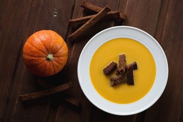 Above view of pumpkin cream-soup with croutons