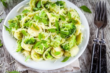 homemade pasta orecchiette with broccoli, Parmesan cheese and basil