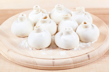 Manti dumplings on a wooden board