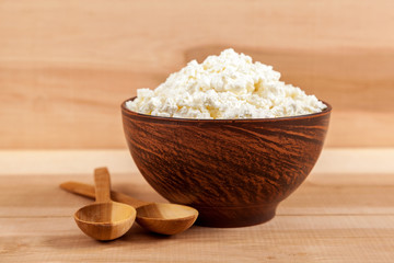 Fresh cottage cheese in a bowl with spoon.