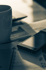 smartphone on Laptop and wooden table. The view from the top