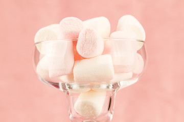 sweet marshmallows on a pink background