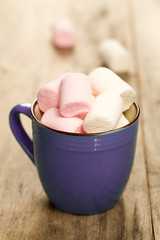 sweet colorful marshmallow in a cup on wooden background