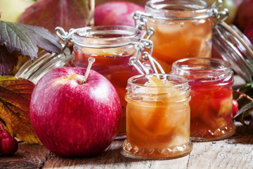 Homemade apple jam in banks in the autumn background with ripe a
