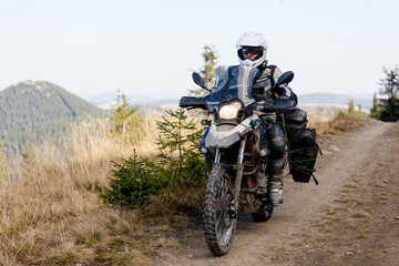 Obraz na płótnie Canvas Motorbiker travelling in autumn mountains