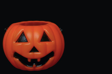 Plastic pumpkin black background