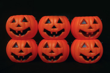 Plastic pumpkins stacked on each other background