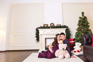 portrait of a pregnant woman near the Christmas tree