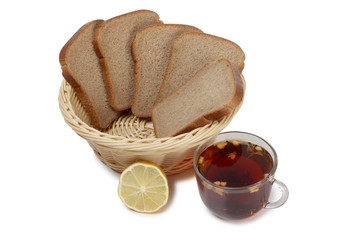Wicker basket with black bread and tea on a white background