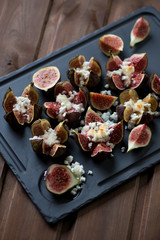 Basalt plate with fig fruits baked with cottage cheese and honey
