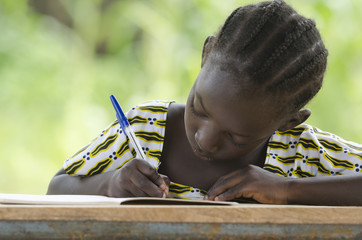 Writing for a Better Future - African Schoolgirl Doing Homework Outdoors