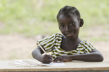 Portrait of gorgeous African Girl Doing Homework and Math Exercises Outdoors