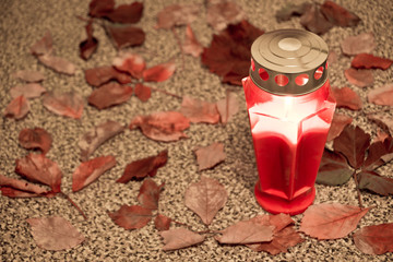 cemetery red lantern candle with autumn leaves 