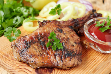 Gourmet grilled pork steak with vegetables and ketchup,horizontal