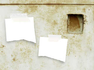 Two ripped pieces of paper with tape on metal rusty background