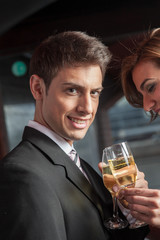 Young couple in love making a toast