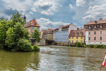 Fototapeta na wymiar Bamberg. A scenic view of the Regnitz river with the Old Town Hall and the old buildings on the left bank
