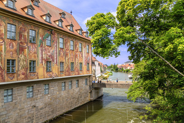 Bamberg. Wall of the Old Town Hall (1461) with frescoes (1756) and Lower Bridge.   Historic city center of Bamberg is a listed UNESCO world heritage site 