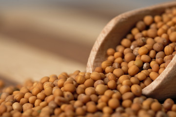 Mustard seed on a wooden, two colored board.