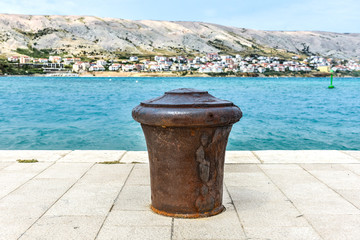Naklejka premium Steel Mooring on a stone pier