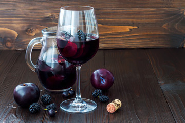Black sangria with plums and berries. Copy space background