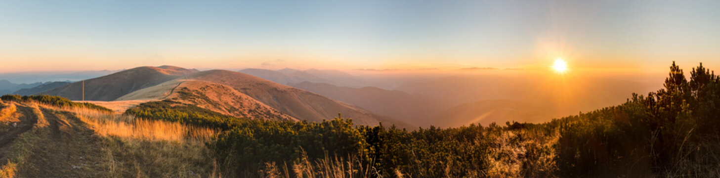 Panorama of amazing sunrise on mountain ridge