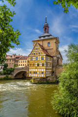 Fototapeta na wymiar Bamberg, Germany. Old Town Hall (1461), and half-timbered extension Corporal House (1668). Historic city center of Bamberg is a listed UNESCO world heritage site