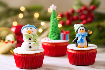 Three decorative christmas cupcakes with tradition background