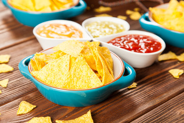 Plate of nachos with different dips