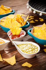 Plate of nachos with different dips
