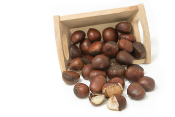 roasted chestnuts in wooden bowl on white background