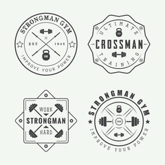 Set of gym logos, labels and slogans in vintage style
