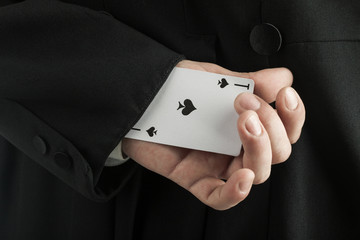 magician holding playing cards